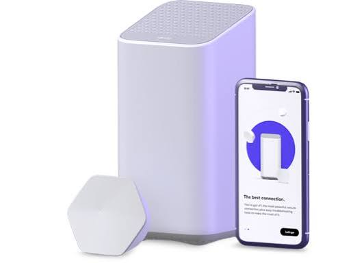 Xfinity WiFi gateway and pod with the Xfinity app open on a phone